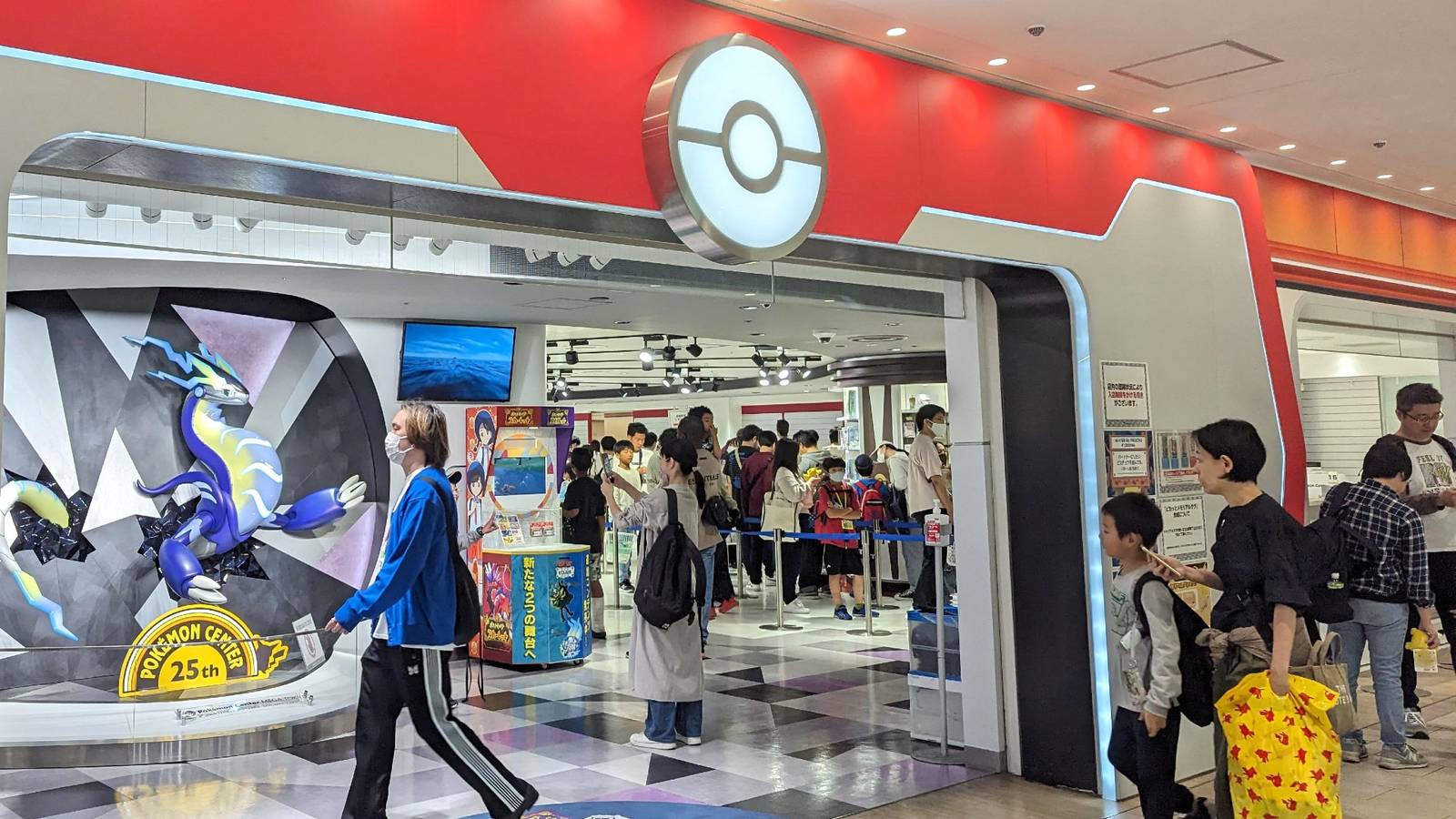 There are several people inside the Pokemon Center.