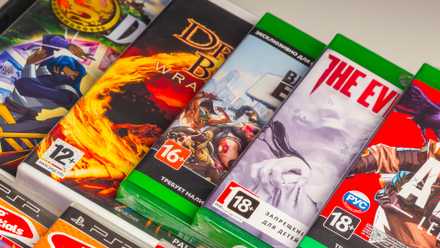 Xbox physical games on a shelf over one another.