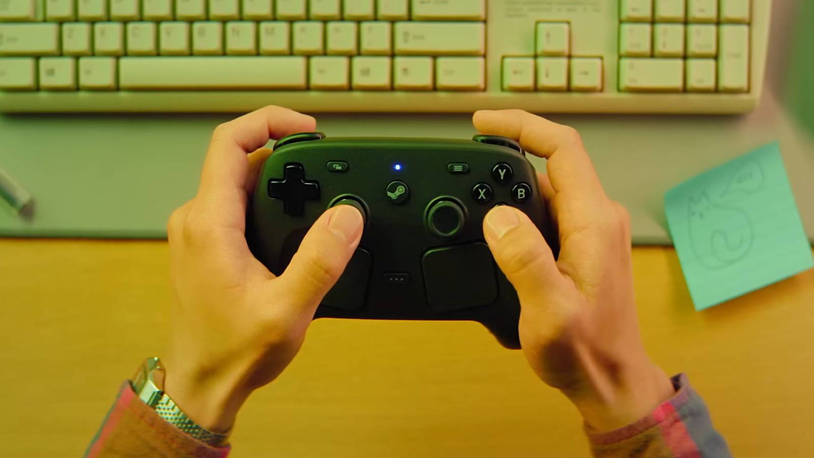 A person holding a Steam controller