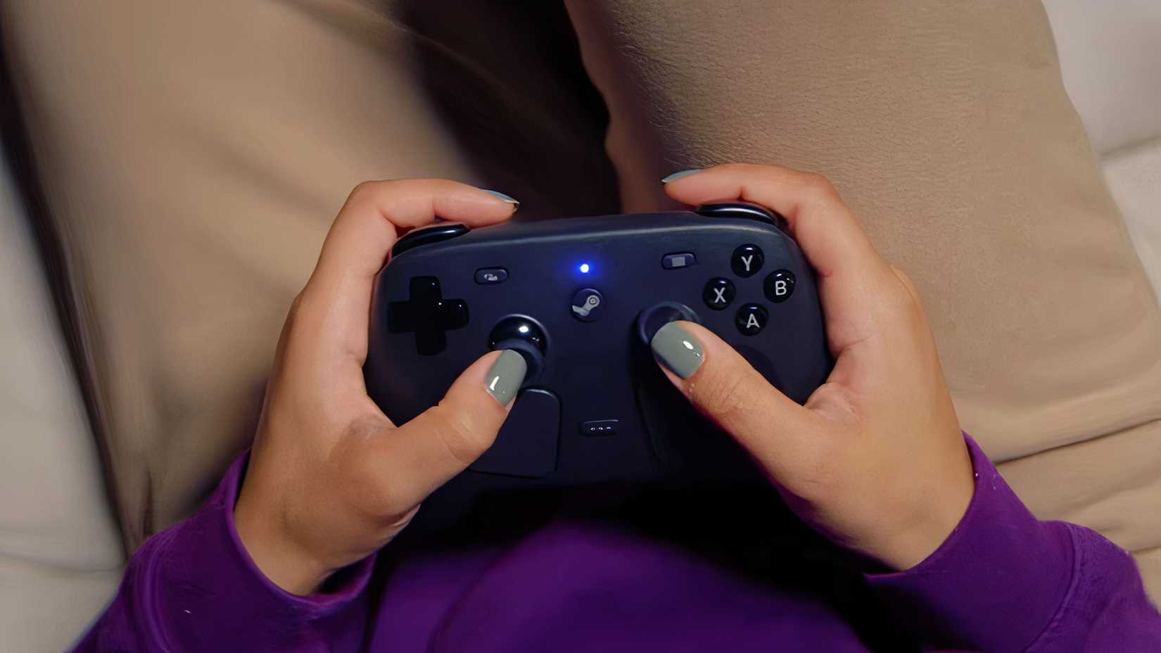 Close-up of a person's hand using a Steam Controller.