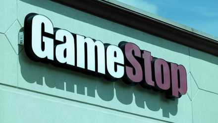A photo of the GameStop logo in a blue colored shop.