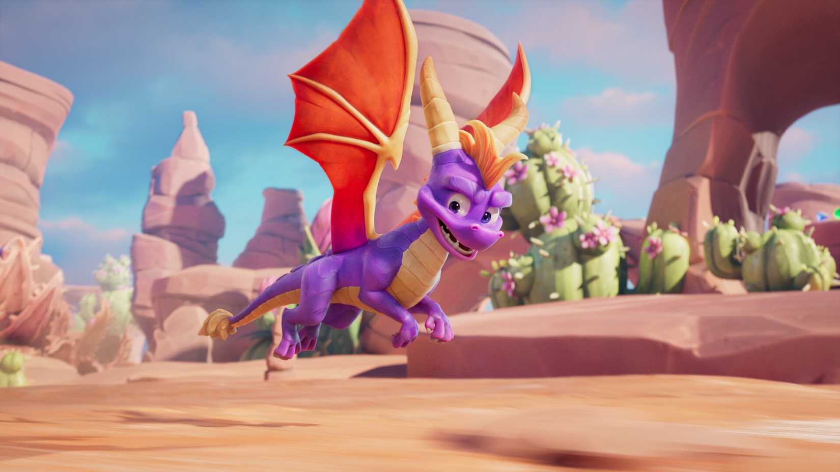 Spyro flies across desert land in Spyro A Realm Beyond.