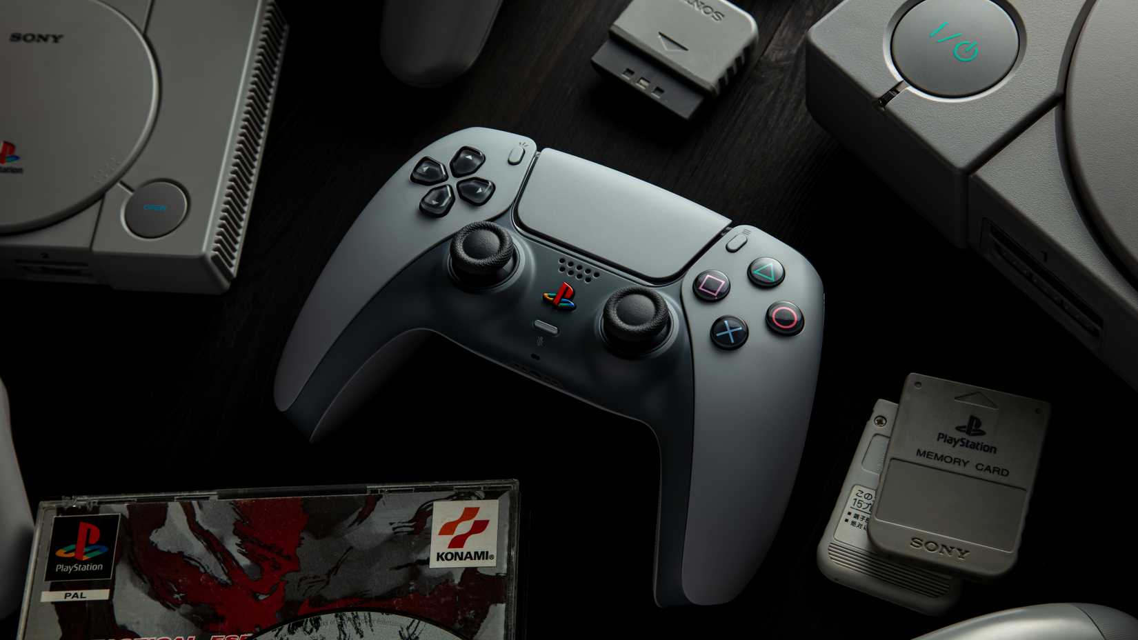 Anniversary DualSense PS1 console and surrounded by games.