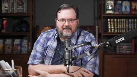 Brandon Sanderson stares at the camera in a YouTube video.