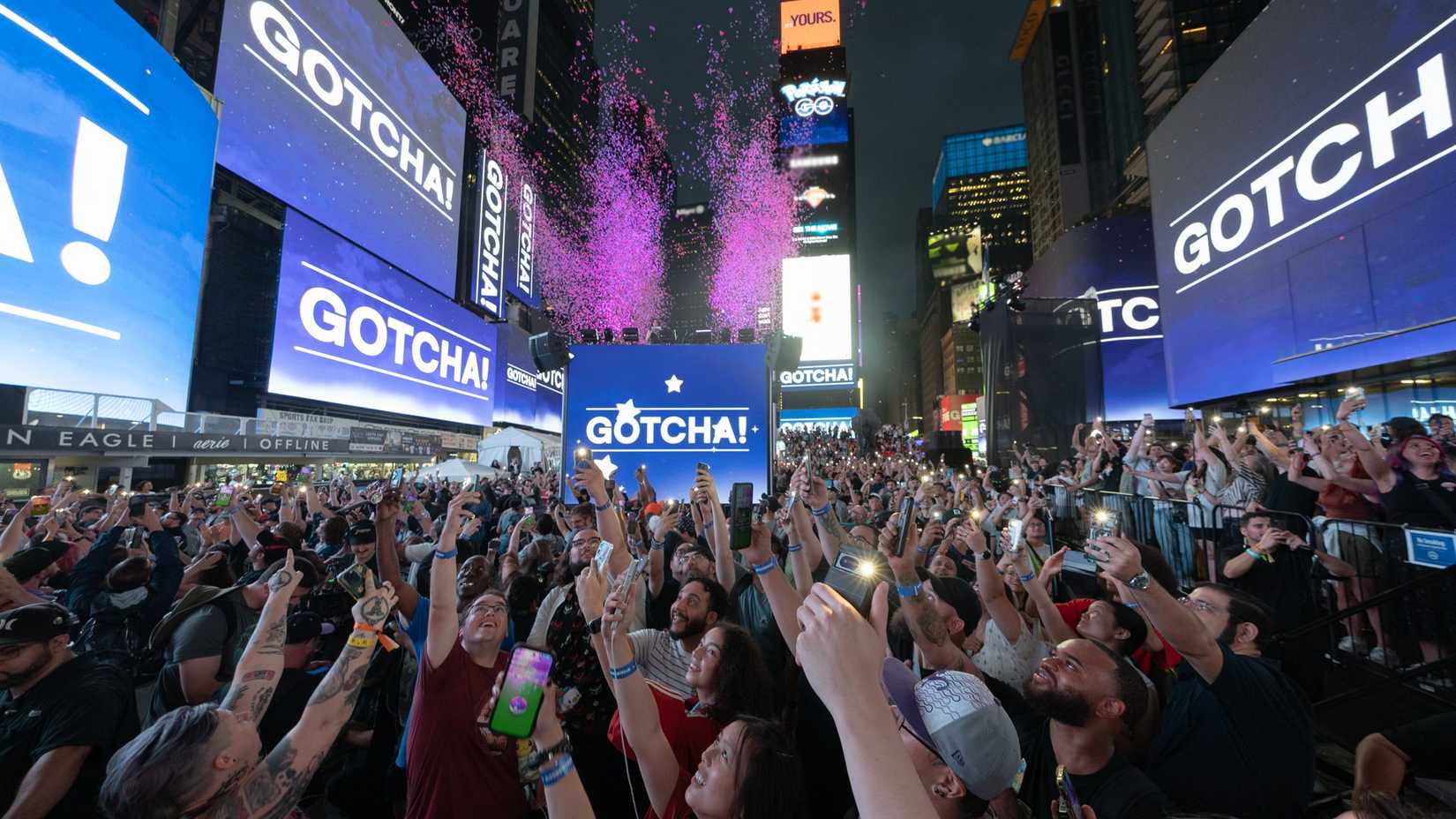 pogo influencers in Times Square hold up their phones.