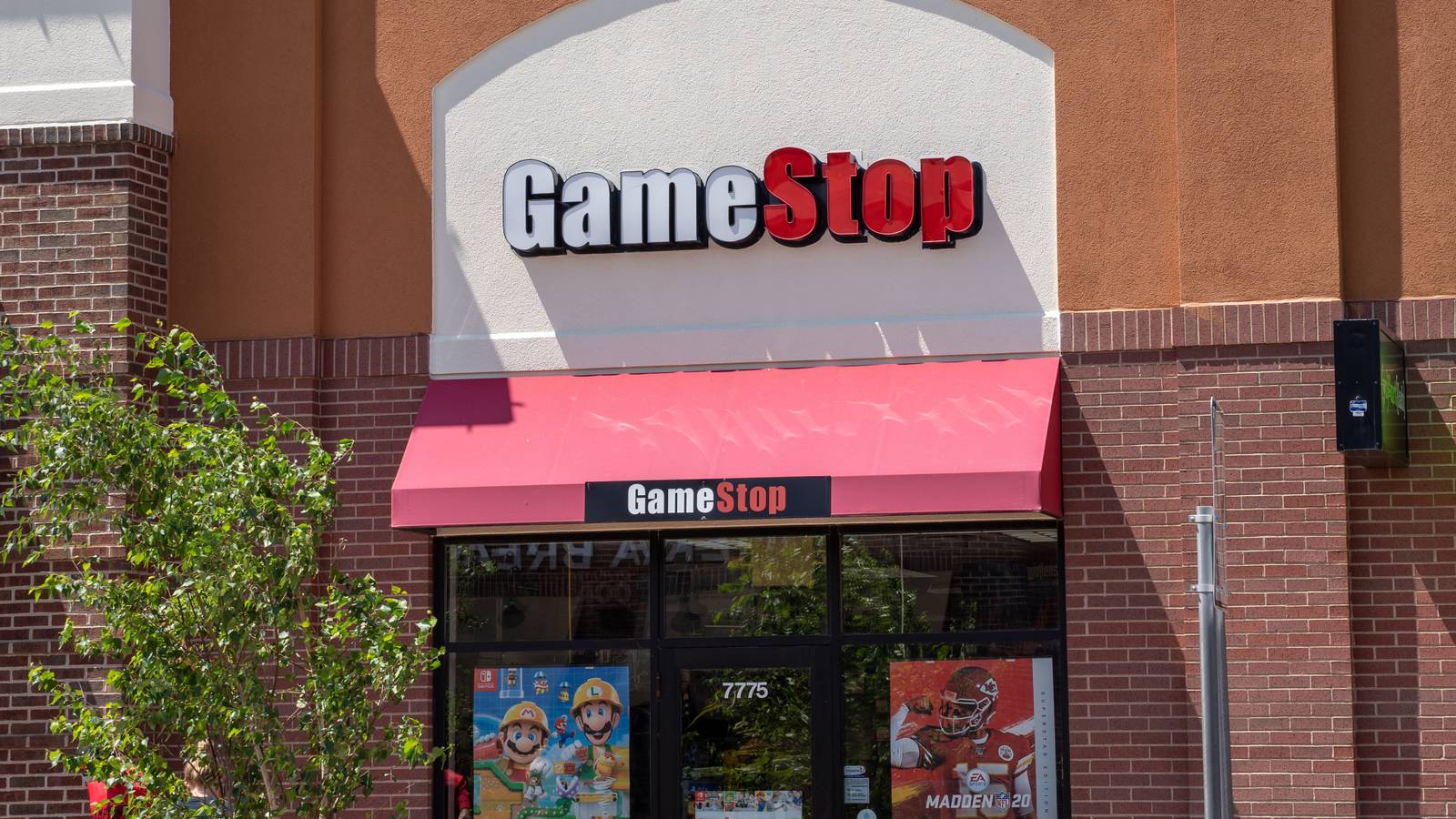 Front of a GameStop store with Mario Maker and Madden NFL 20 posters in the window.