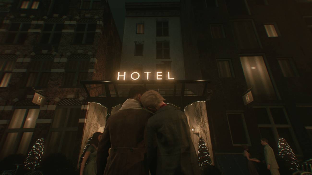 A couple standing arm in arm while looking at a hotel in Amsterdam.
