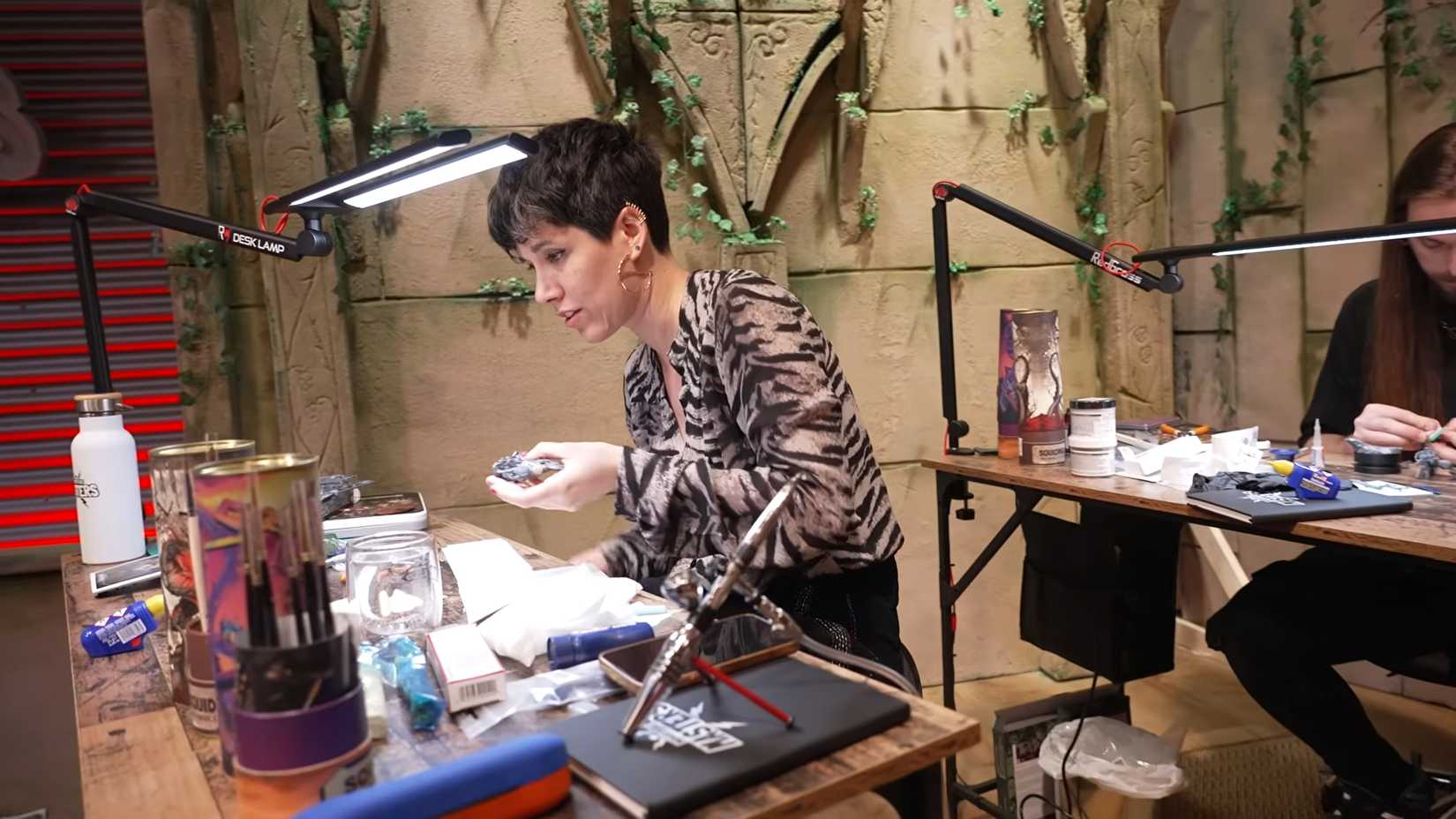 A girl begins to assemble and paint in Miniature Masters