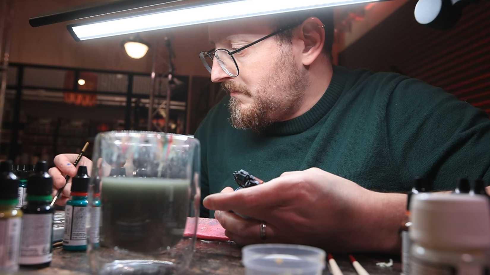 A man paints at Miniature Masters. 