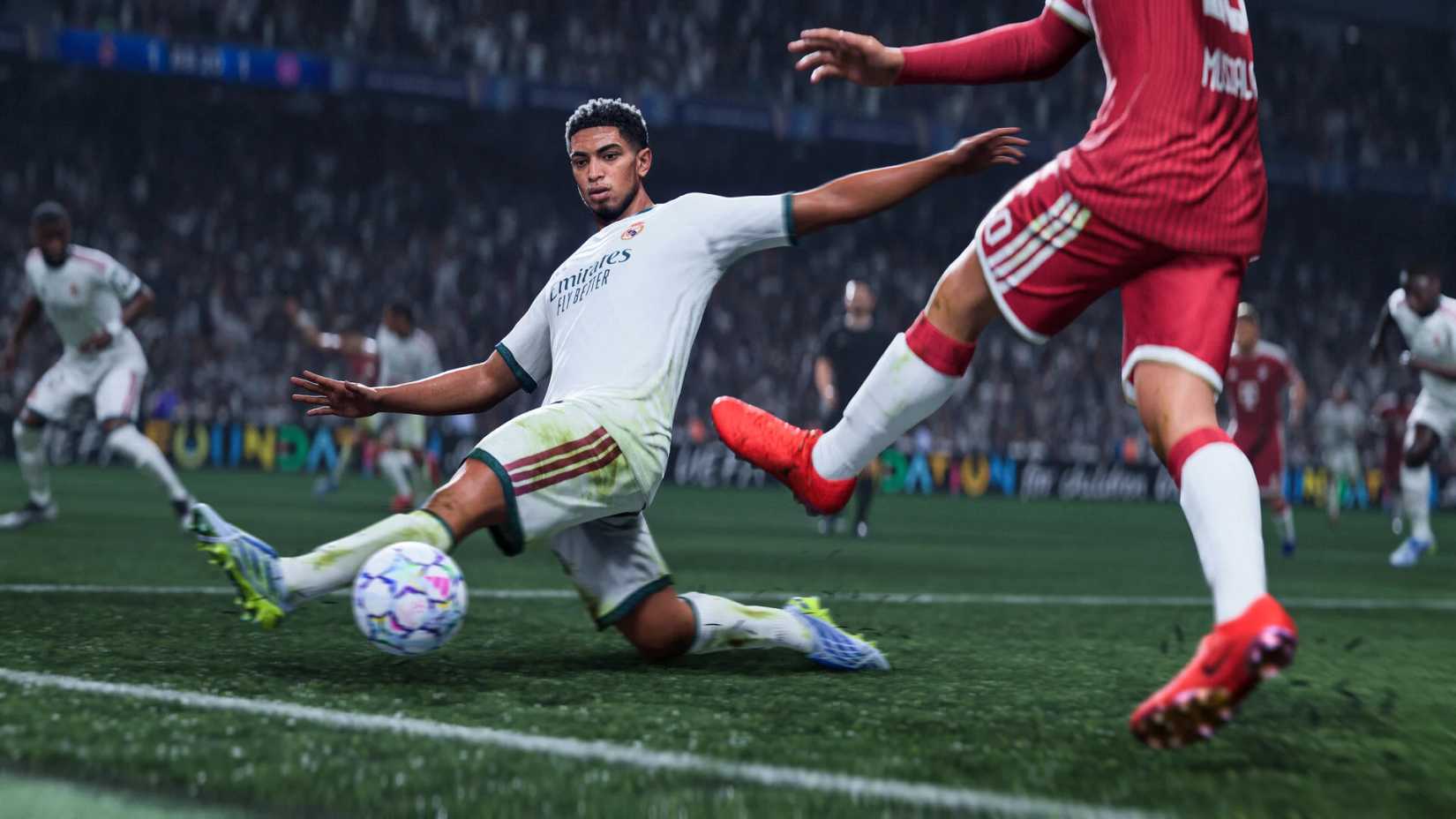 An image of Jude Bellingham in FC 27 streatching out to make a sliding tackle against a player wearing a red kit.