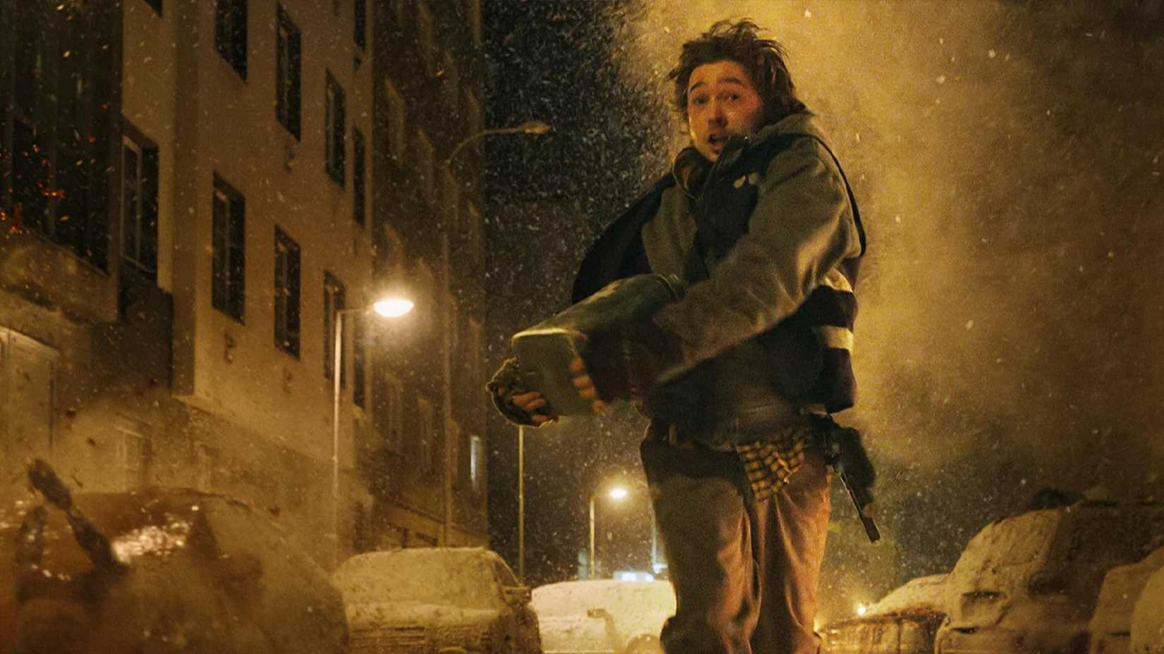 Resident Evil movie protagonist running through the snowy streets as zombies fall from above.