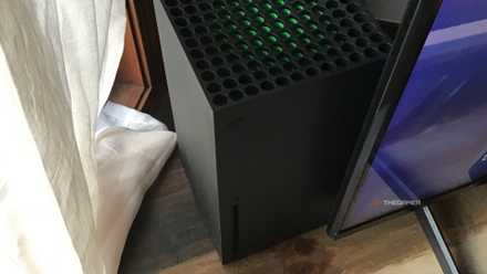 Xbox Series X console standing next to the TV.