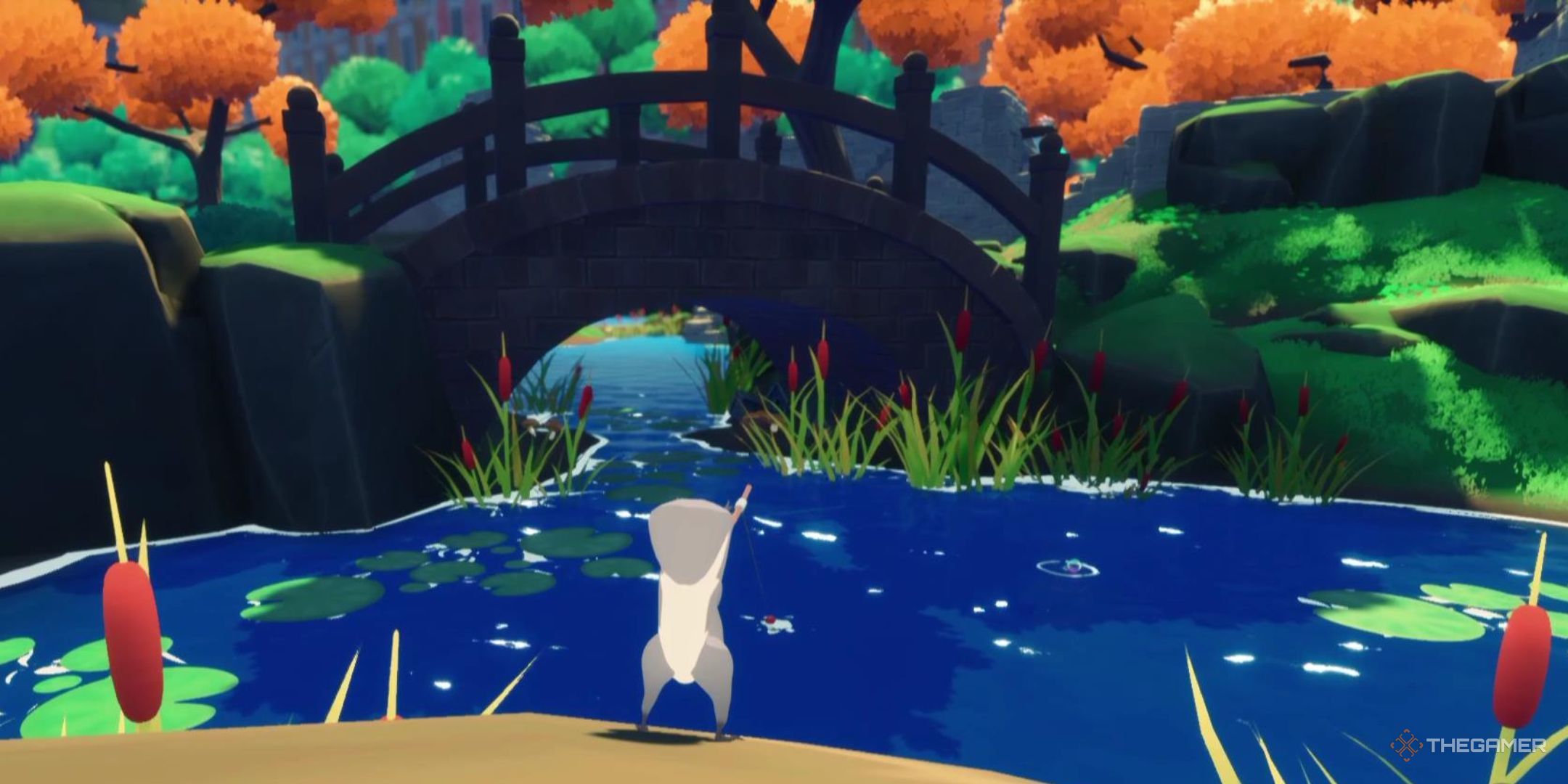 A squirrel stands fishing in a small pond in front of a beautiful bridge in Squirreled Away.