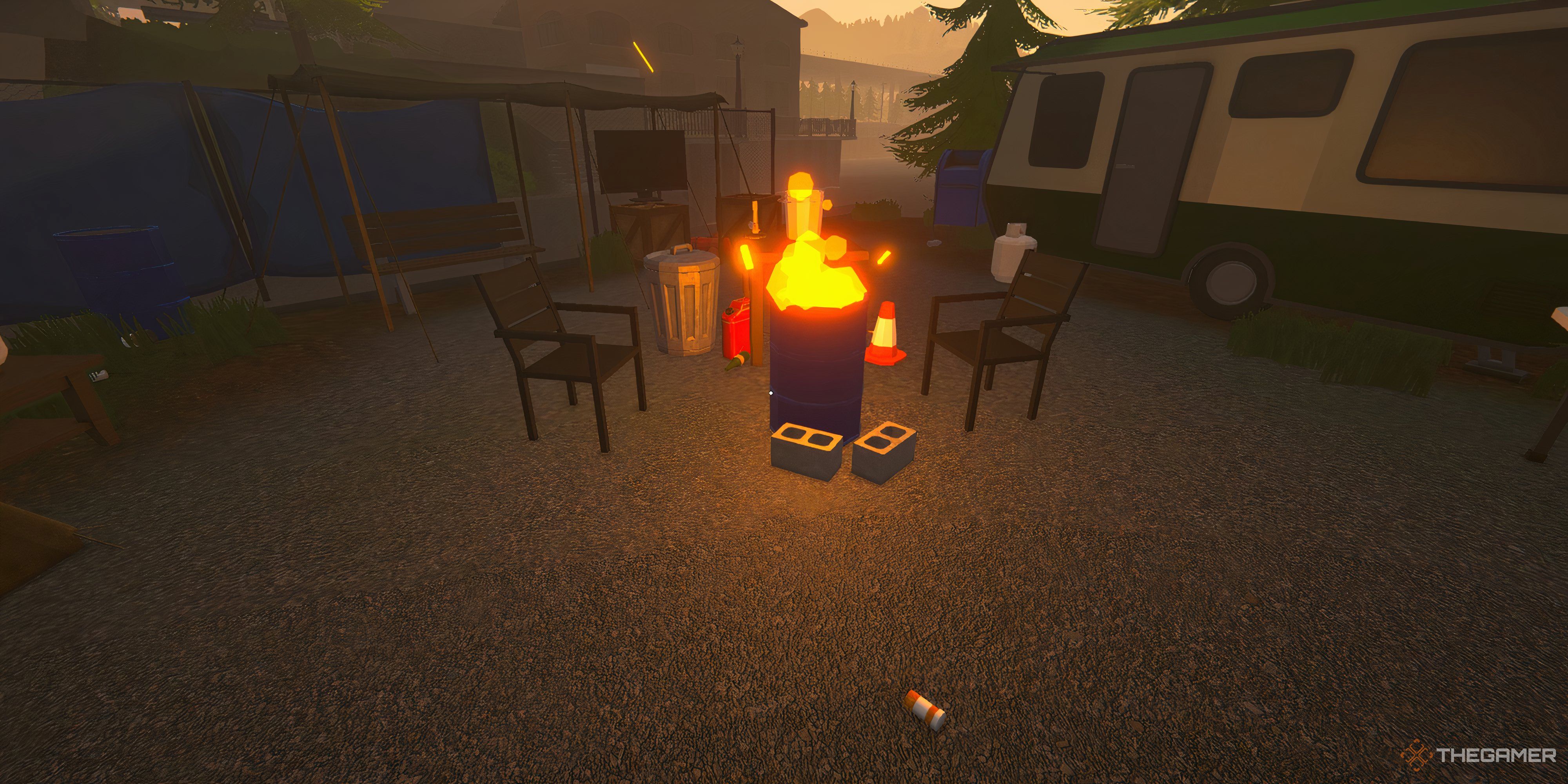 Player looking at a fire coming out of a barrel. There are chairs around it. Behind the fire is an RV. 