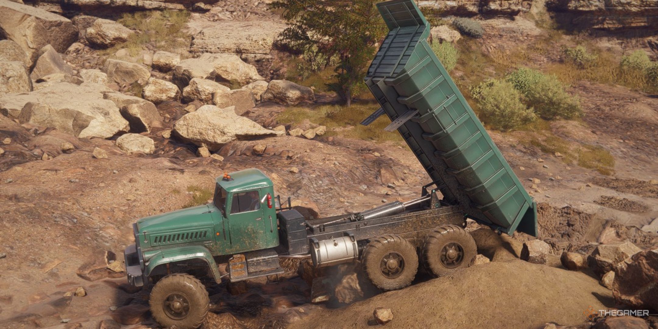a dump truck unloads a pile of sand in roadcraft.