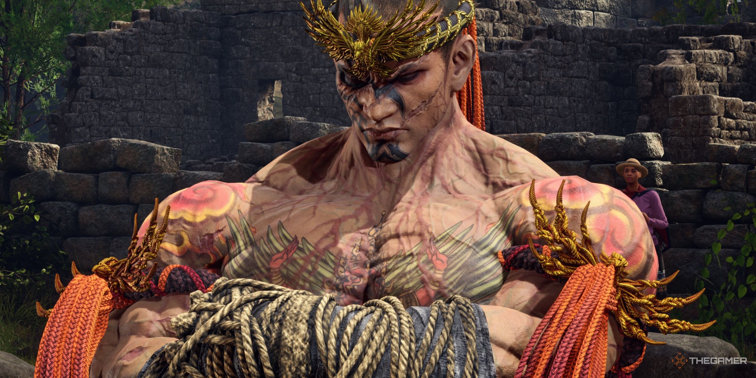 Fahkumram standing with his arms crossed and his eyes closed, emitting a daunting and powerful aura in Tekken 8.