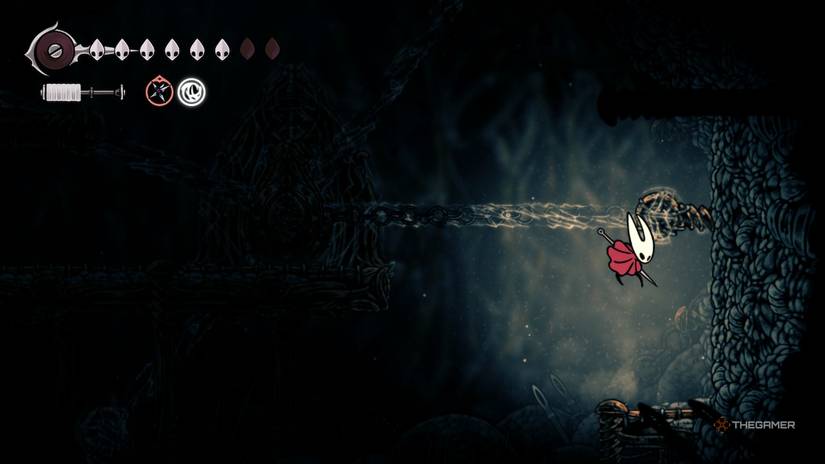 Hornet jumps up to destroy a pin to open First Sinner's jail in Hollow Knight: Silksong.