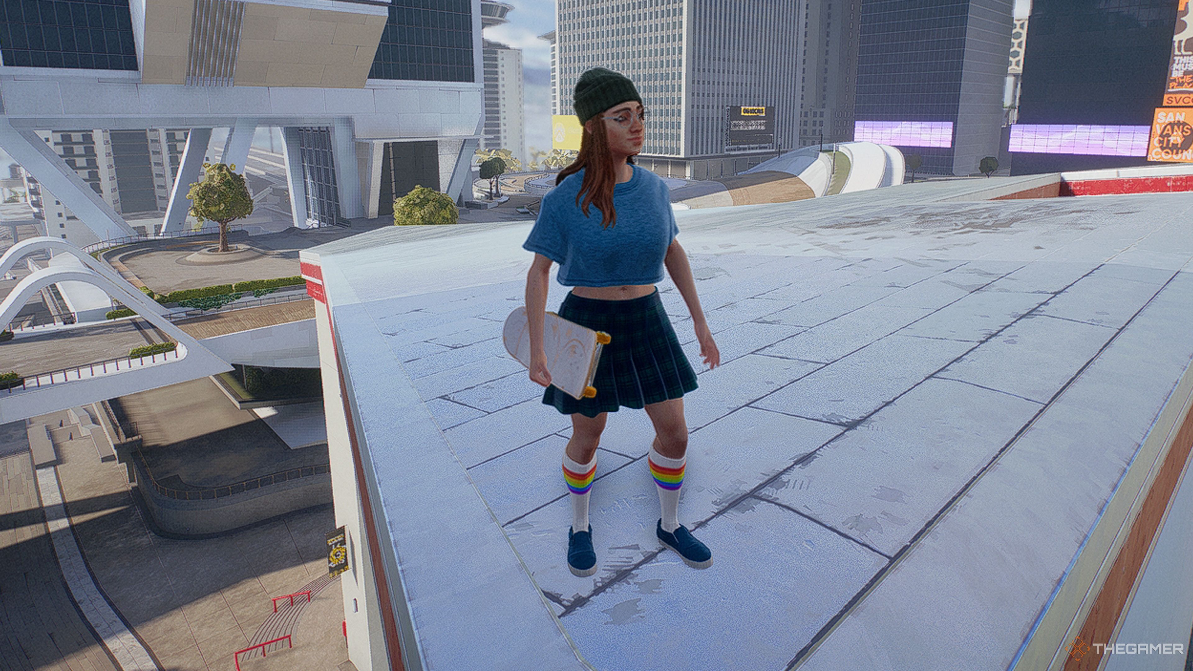Skate a woman in blue standing on a rooftop.