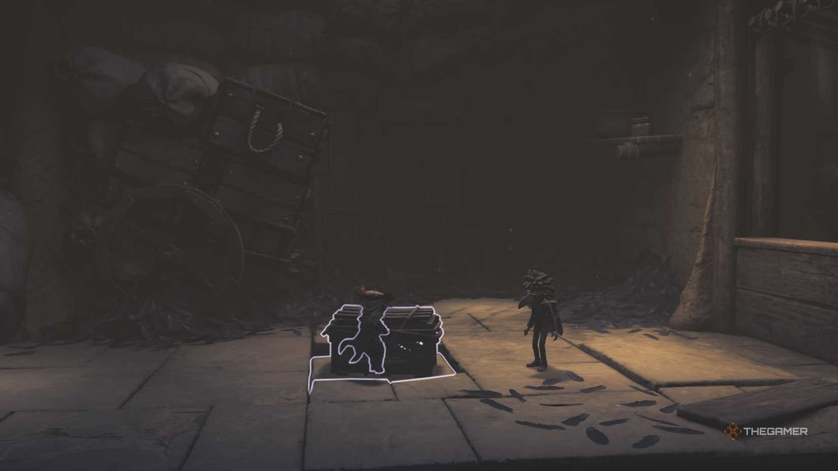 Alone pulling a crate onto a floor tile in Little Nightmares 3.