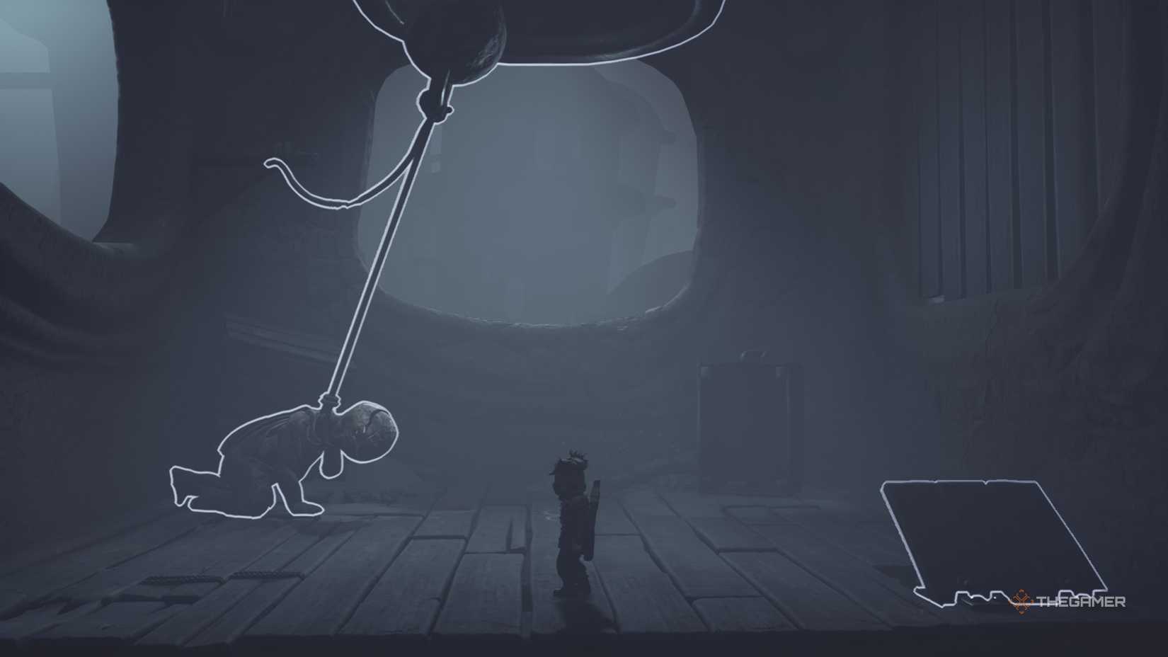 Alone standing in front of a doll statue and a bell in Little Nightmares 3.