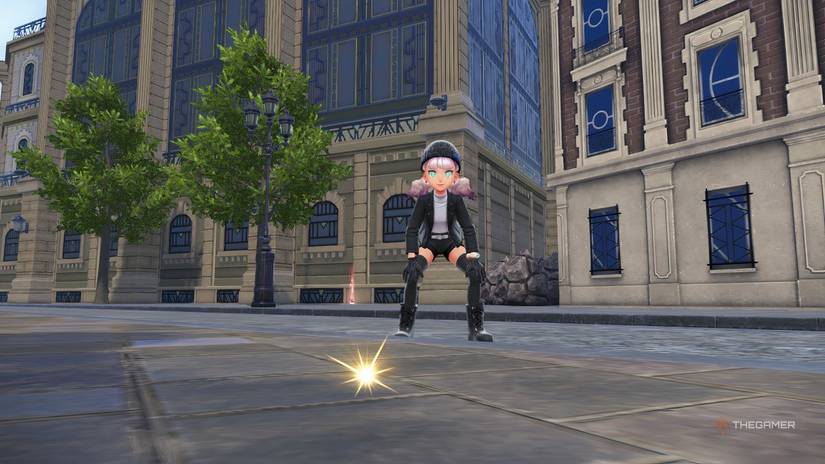 Trainer crouched near a sparkle on the ground in Pokemon Legends: Z-A.