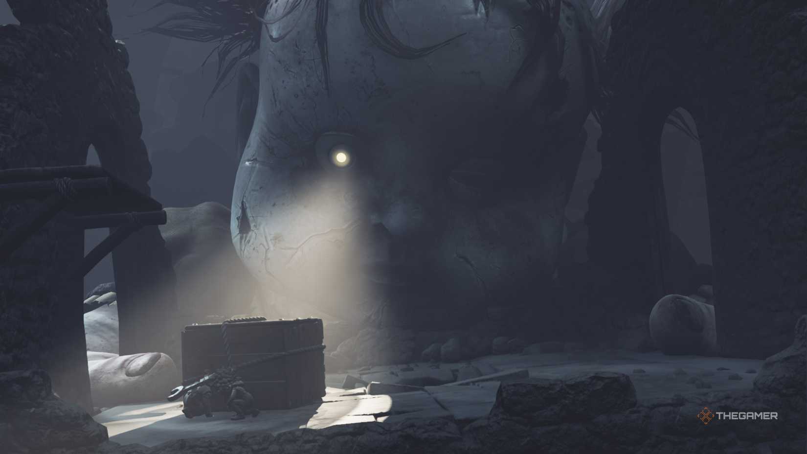 Low and Alone hiding behind a crate from Monster Baby in Little Nightmares 3.