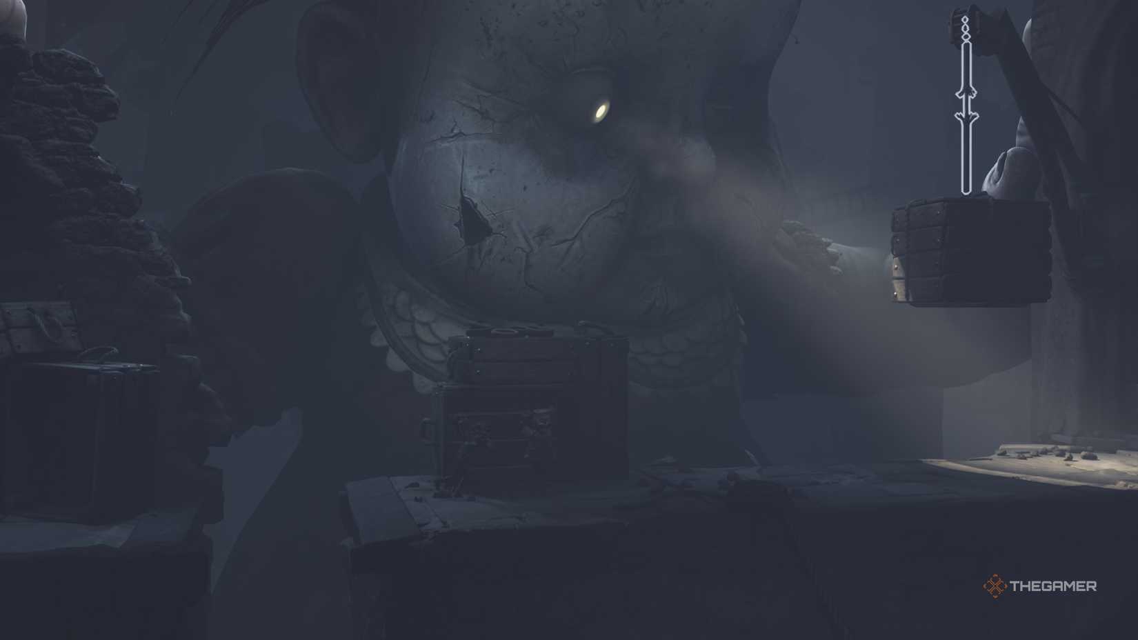 Low and Alone hiding behind a crate in Little Nightmares 3.