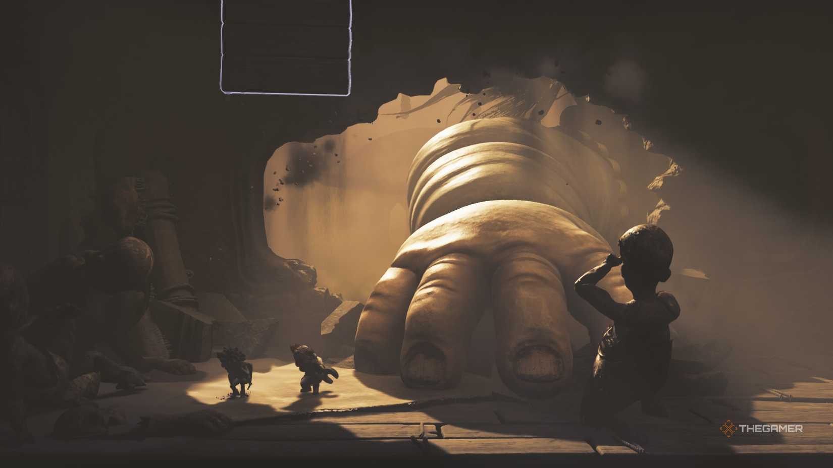 Low and Alone hiding from a large baby hand in Little Nightmares 3.