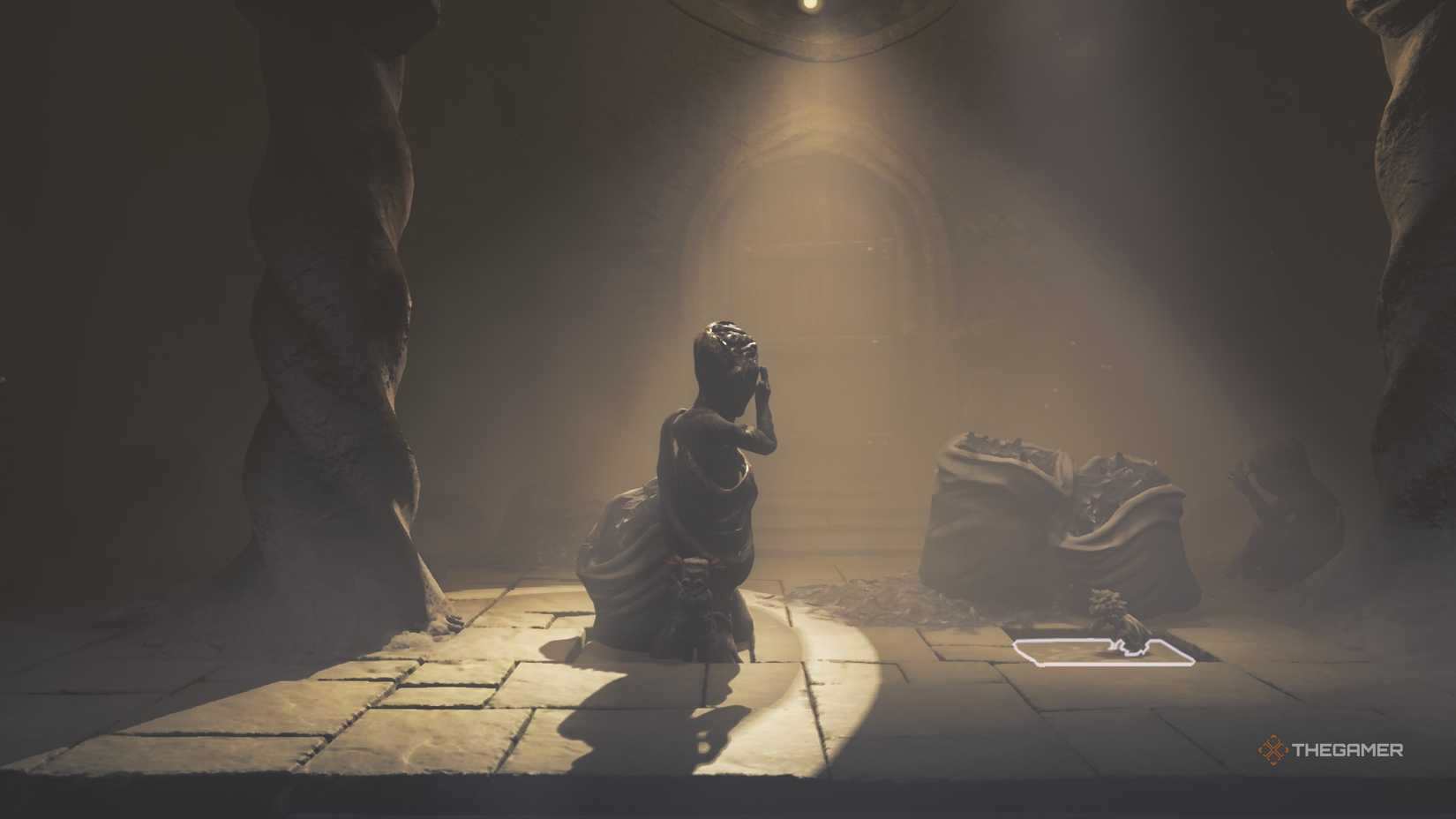 Low crouched on a moving floor tile in Little Nightmares 3.
