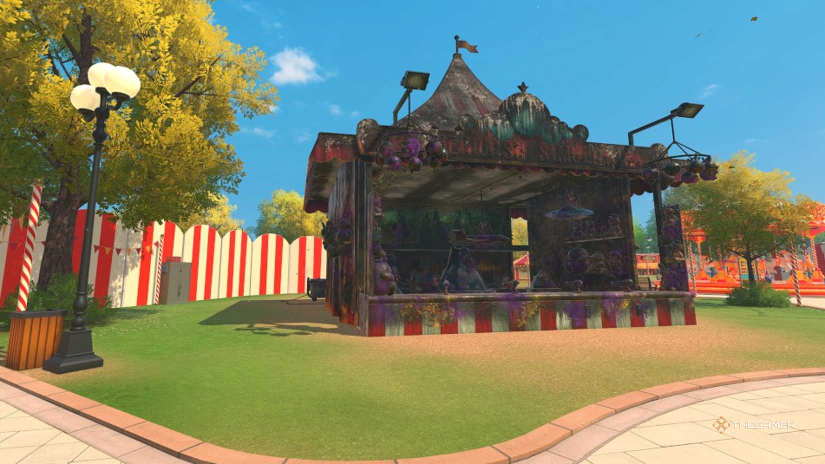 the dirty carnival shooting gallery stands in an otherwise-clean park in powerwash simulator 2.