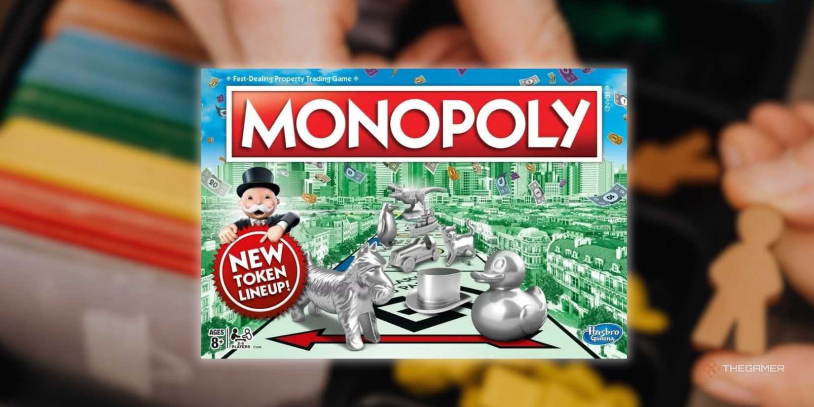 The cover of Monopoly in front of a blurry image of someone preparing to play a board game.