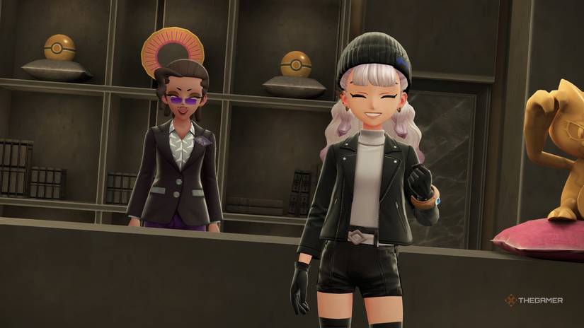 Lady Clear and a trainer at the Rust Syndicate in Pokemon Legends: Z-A.