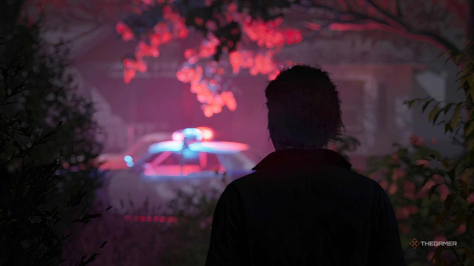 Michael Myers from behind looking at a police car in the distance in Halloween. - Copy