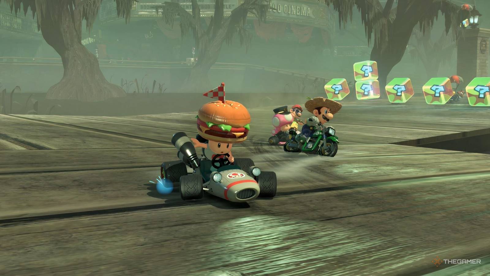 toad wearing a burger hat racing mario, luigi, and toadette.