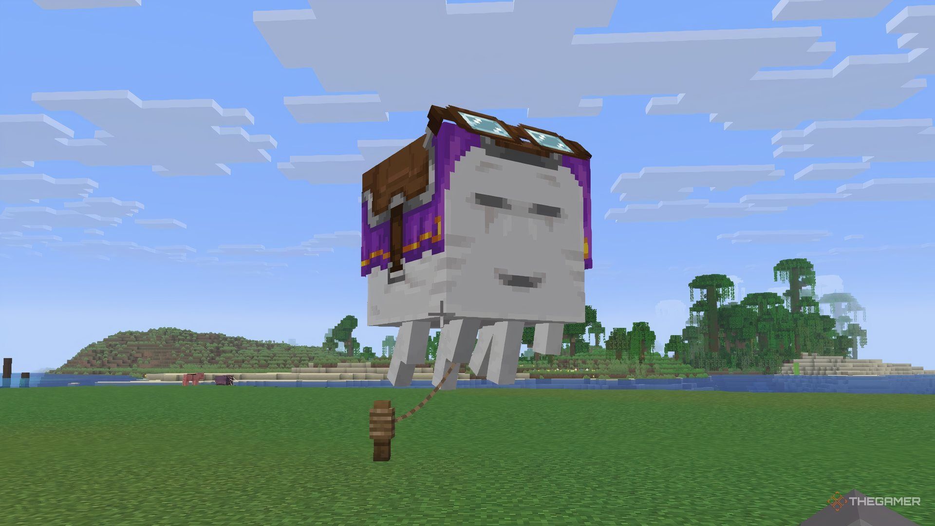 A happy ghast with a harness and lead in Minecraft on an island.
