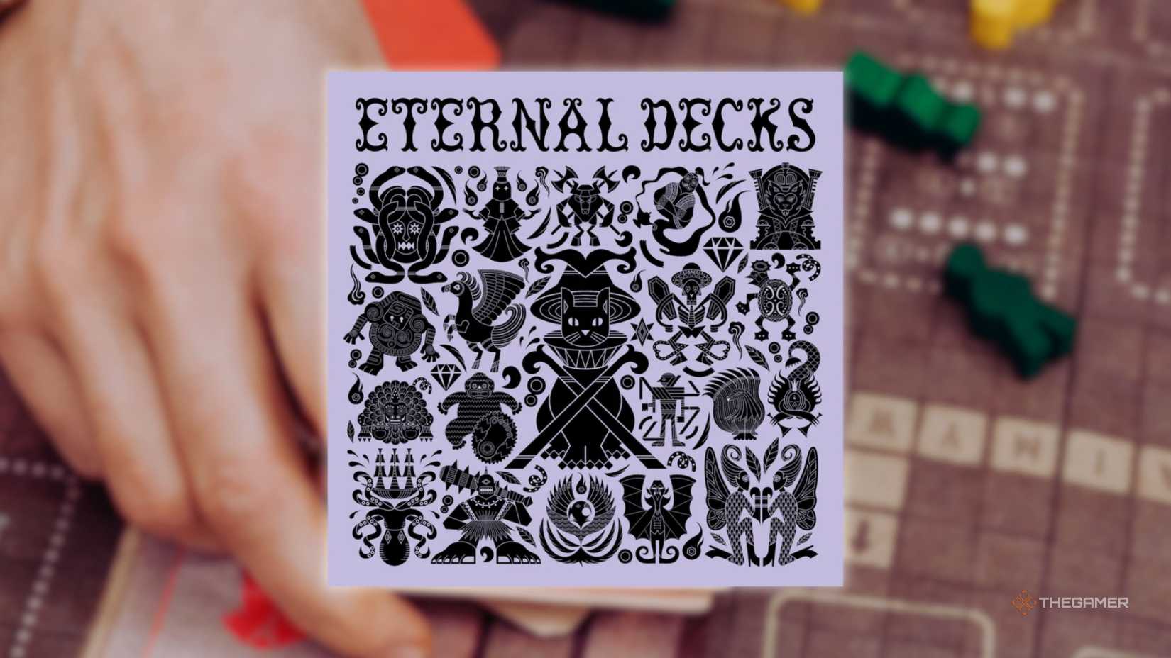 The cover of Eternal Decks in front of a hand playing a grid-based board game for the best board games of 2025.