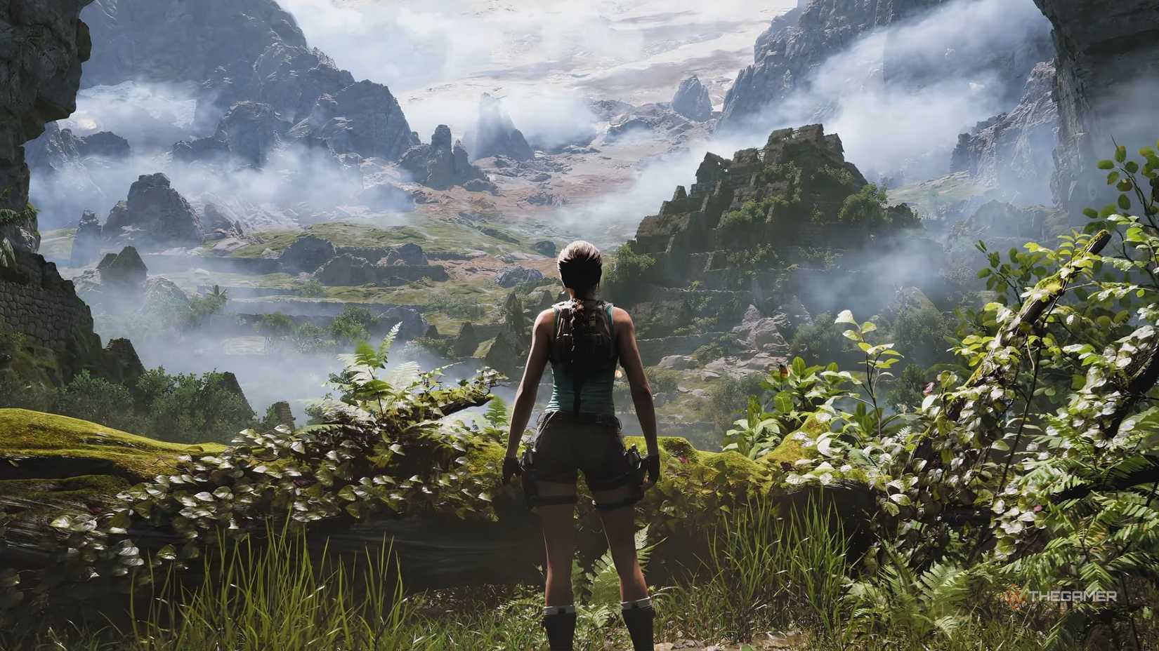 A screenshot of Lara Croft from Tomb Raider Legacy Of Atlantis taken from behind as she looks out into the jungle, desert and mountains ahead.-1