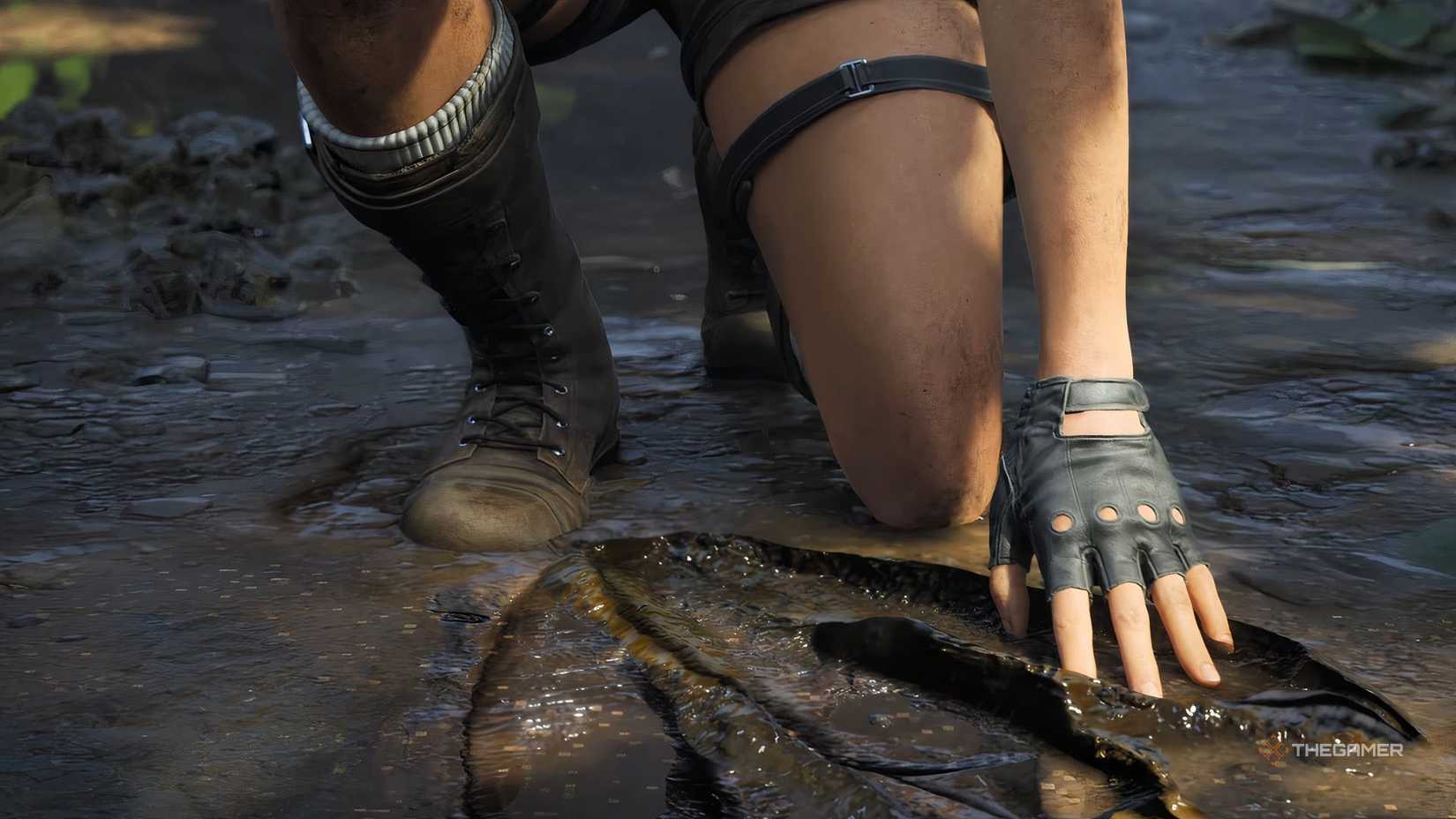 Tomb Raider Legacy of Atlantis screenshot Lara's shoes and dirt as she kneels down to examine the dino footprints.-1