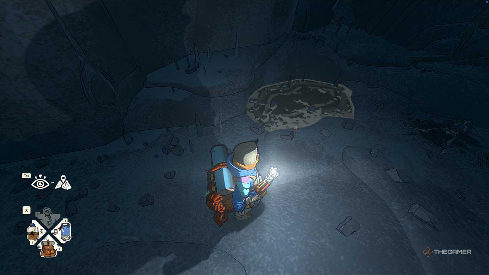 Aava looks at a frog in a cave in Cairn.