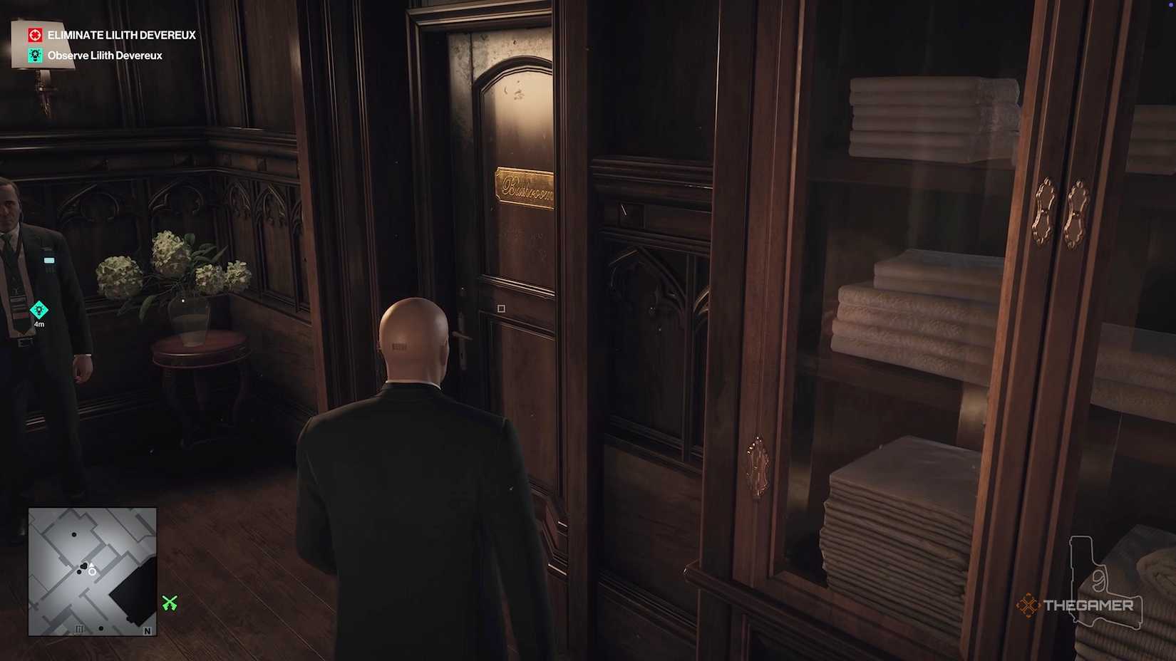 Agent 47 about to enter a bathroom in Hitman World of Assassination.