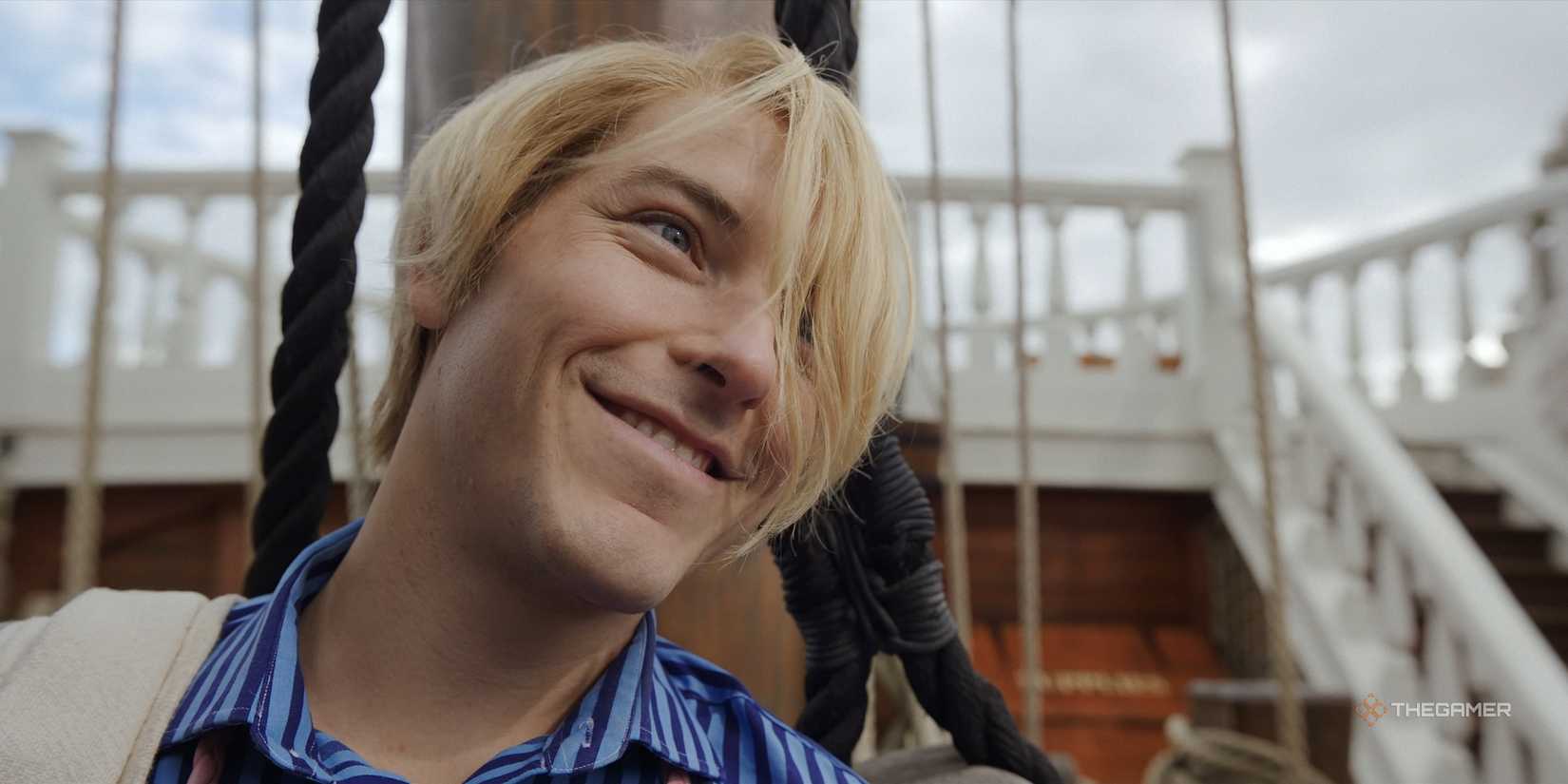 Close-up of Sanji smiling while listening to his crew in Netflix's One Piece Season 2.