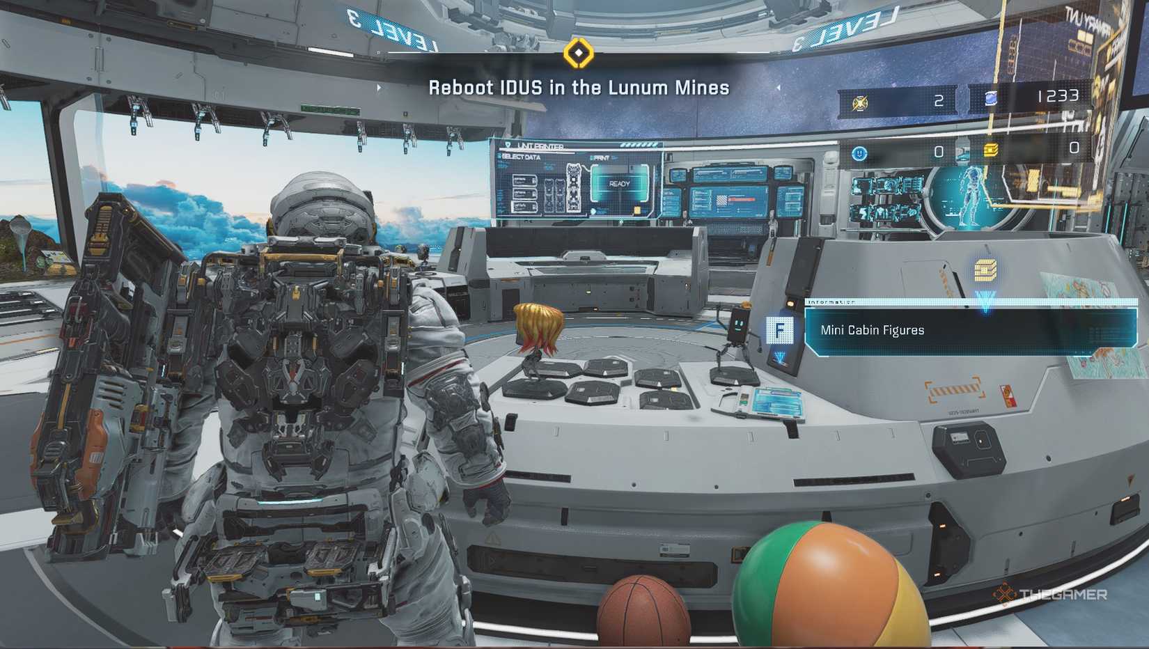 Hue Pragmata's shelter looking at a mini cabin figure.