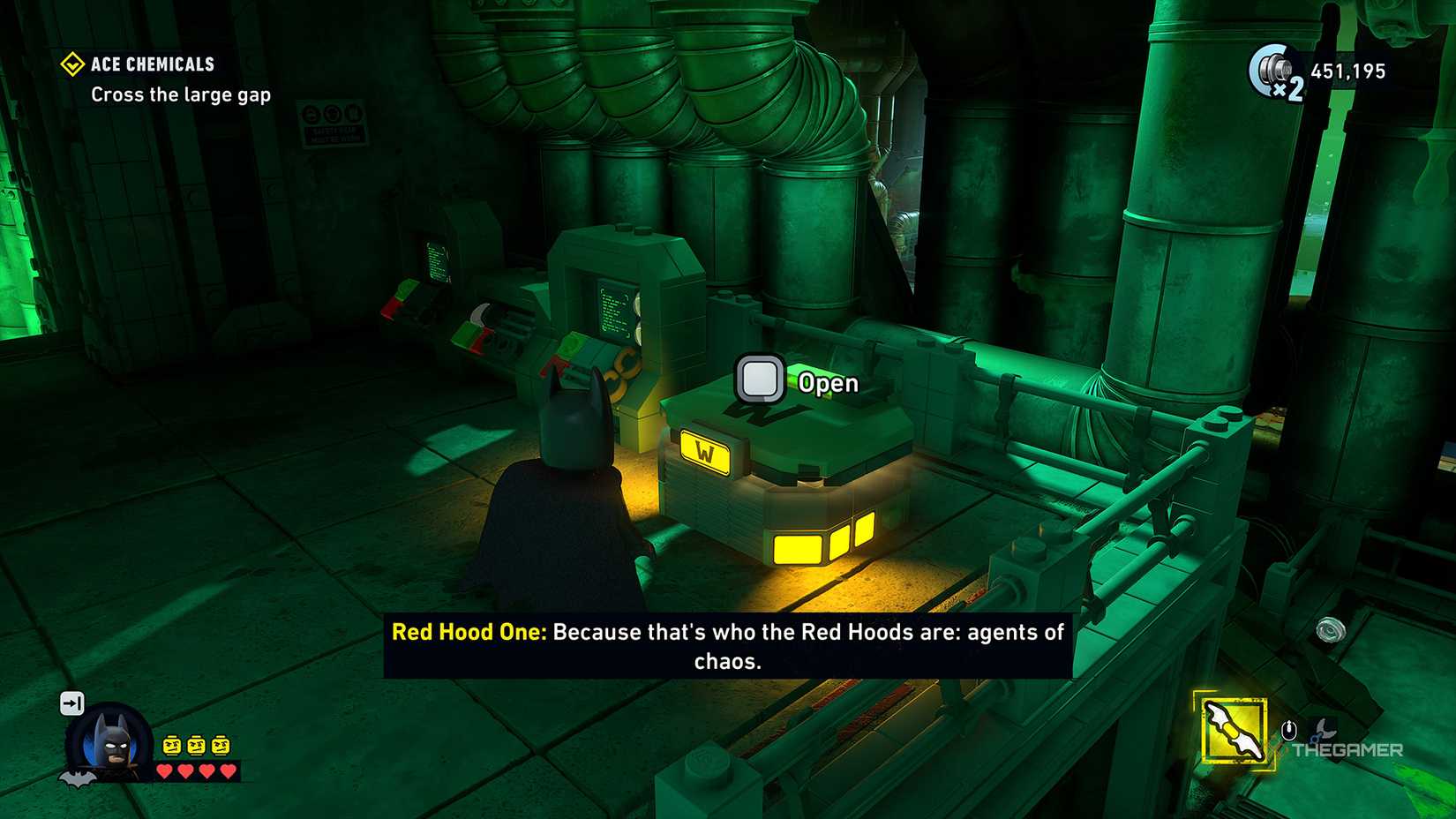 Batman looking at the Waynetech cache in LEGO Batman Legacy of the Dark Knight.