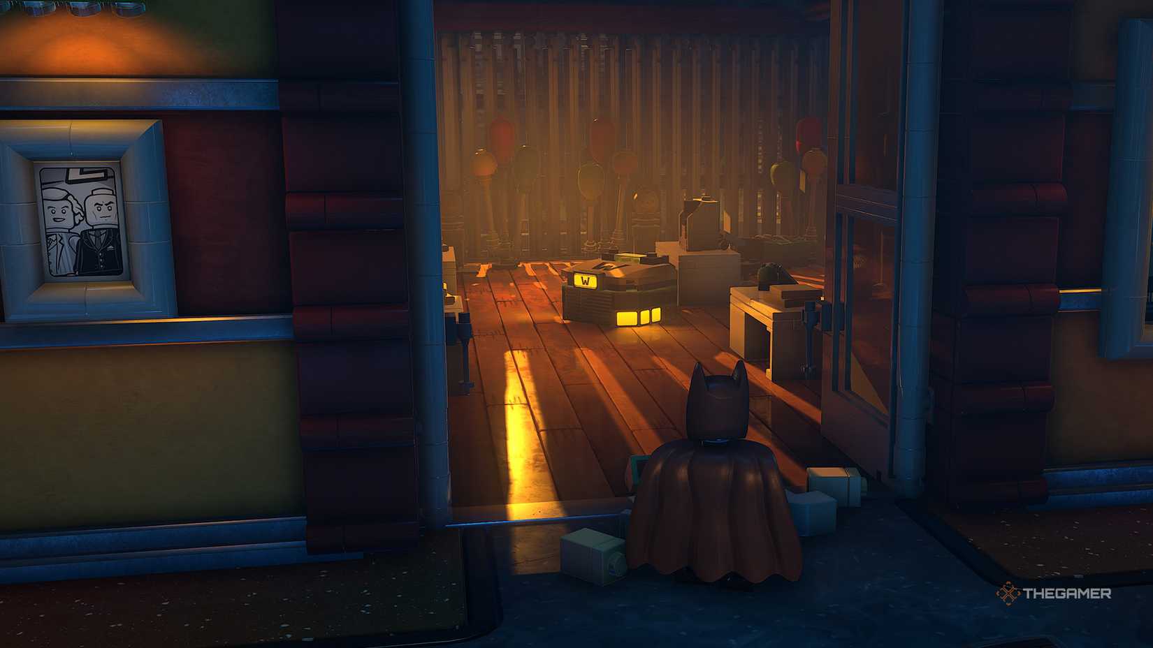 Batman looks through an open door at a WayneTech cache in Lego Batman Legacy of the Dark Knight.