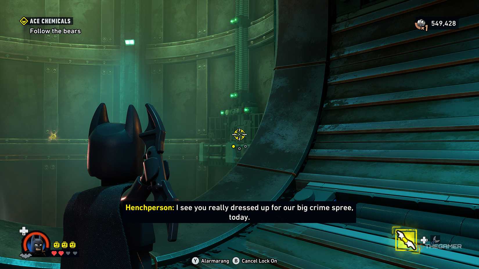 Batman preparing to throw a batarang at the console in LEGO Batman Legacy of the Dark Knight.