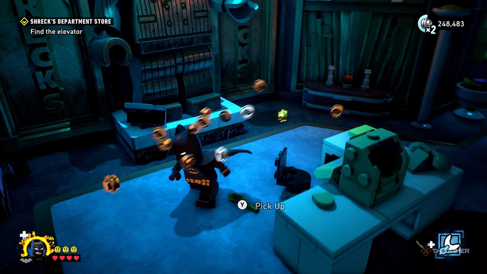 Batman runs past a key on the floor in Lego Batman Legacy of the Dark Knight.