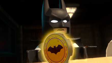 Batman showing the bat-symbol on the table in LEGO Batman: Legacy of the Dark Knight.