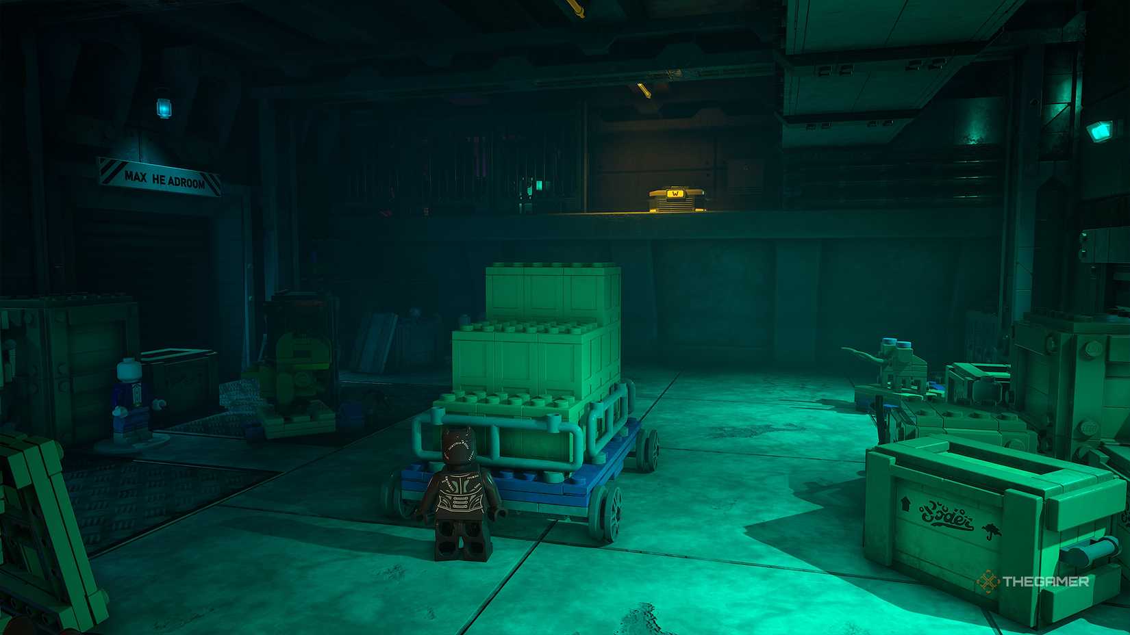 Catwoman standing in front of a cart in front of a ledge with a WayneTech Cache on top in Lego Batman Legacy of the Dark Knight.