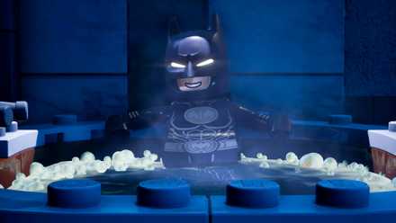 Lego Batman chills in a hot tub in Lego Batman Legacy of the Dark Knight.
