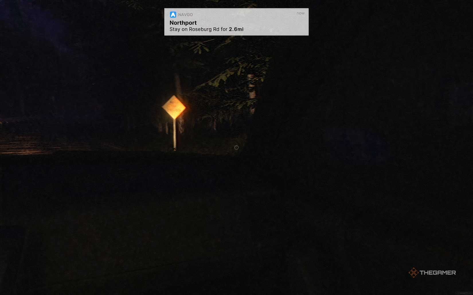 A roadsign being lit up by car lights in the dark with a GPS notification at the top of the screen in Fears To Fathom Scratch Creek.
